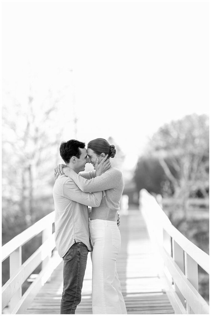Black and White image of newly engaged couple in Nantucket on a bridge in Sconset.