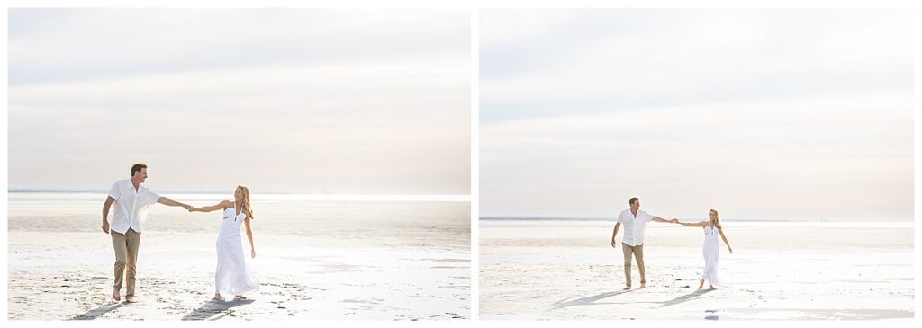Engaged couple dances, and plays in shallow ocean water in Cape Cod at Chapin Memorial beach during engagement pictures.