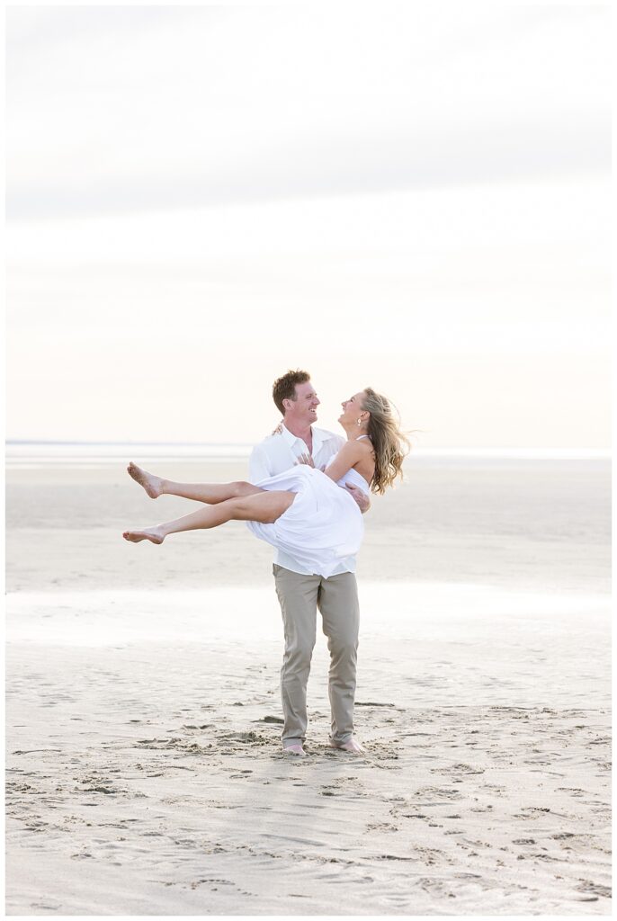 Engaged couple laughs during engagement pictures by Melissa Lacasse Photography at Chapin Beach in Cape Cod.