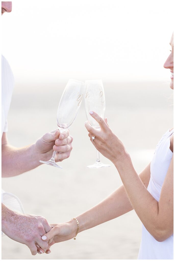 Champagne toast with a newly engaged couple at Chapin Memorial Beach in Cape Cod.