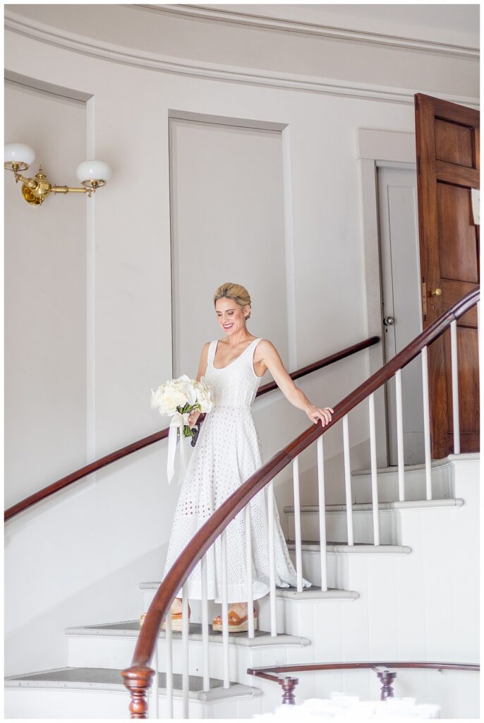 Bride walking down gorgeous stairwell of the Nantucket Unitarian Church for Nantucket wedding.