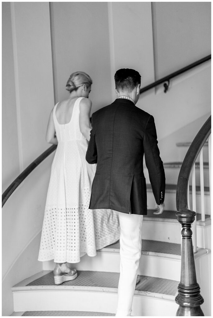 Bride and Groom walking up stairwell at the Unitarian Church in Nantucket for their Nantucket wedding.