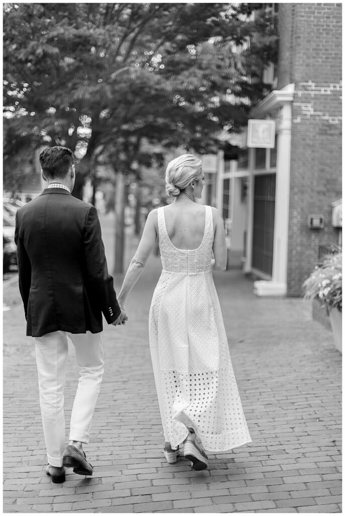 Bride and Groom walk down Main Street holding hands after wedding ceremony in Nantucket.