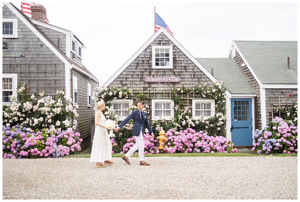 Nantucket bride and groom in front of Constitution house at the Old North Wharf in Nantucket.