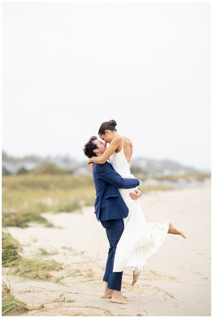 Chatham, MA wedding day with the Bride and Groom walking along the beach in Cape Cod.