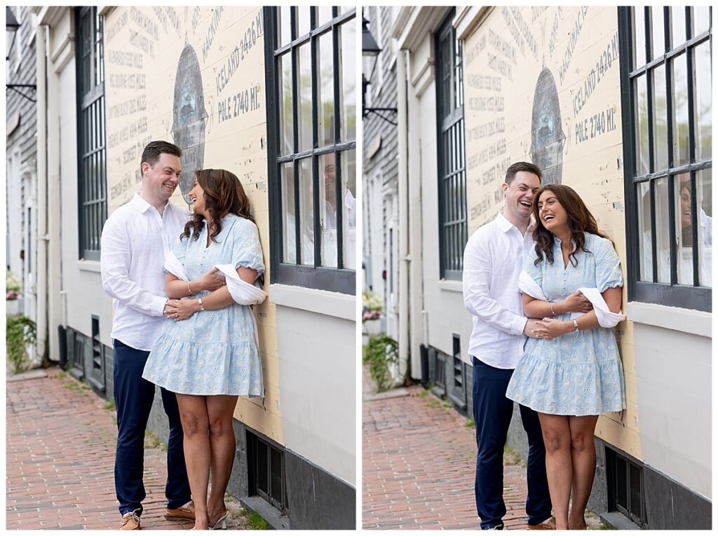 Couple embrace during engagement pictures in downtown Nantucket next to the compass on a beautiful May day.