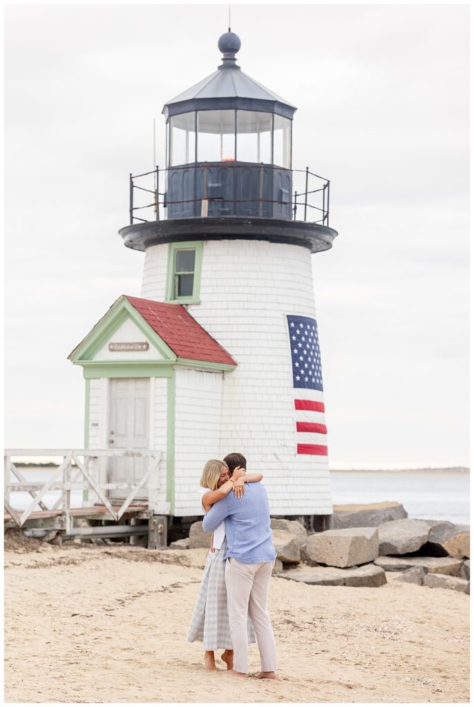 Couple hug and kiss after Nantucket Proposal at Brant Point Lighthouse over Memorial Day Weekend.