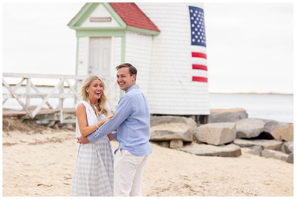 Couple smile and laugh after the mans Nantucket Proposal was a success at Brant Point Lighthouse.