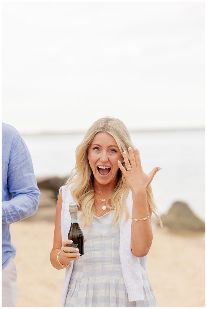 Woman shows off her ring in from of Brant Point Lighthouse in Nantucket after her boyfriend proposed over Memorial Day Weekend.