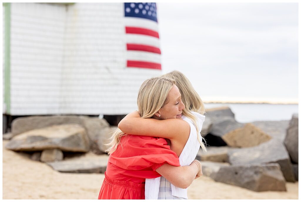 Sisters embrace in excitement after the Nantucket Proposal at Brant Point Lighthouse in Nantucket.