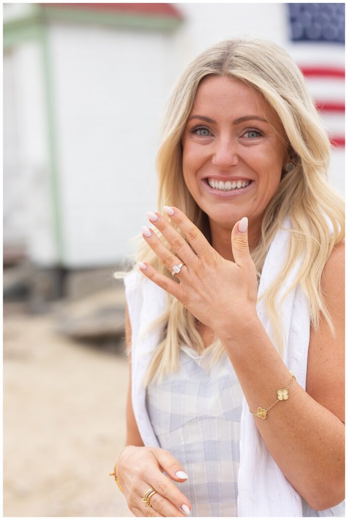Woman shows off her new diamond ring at Brant Point Lighthouse during engagement pictures, after her boyfriends Nantucket Proposal was a success over Memorial Day Weekend.
