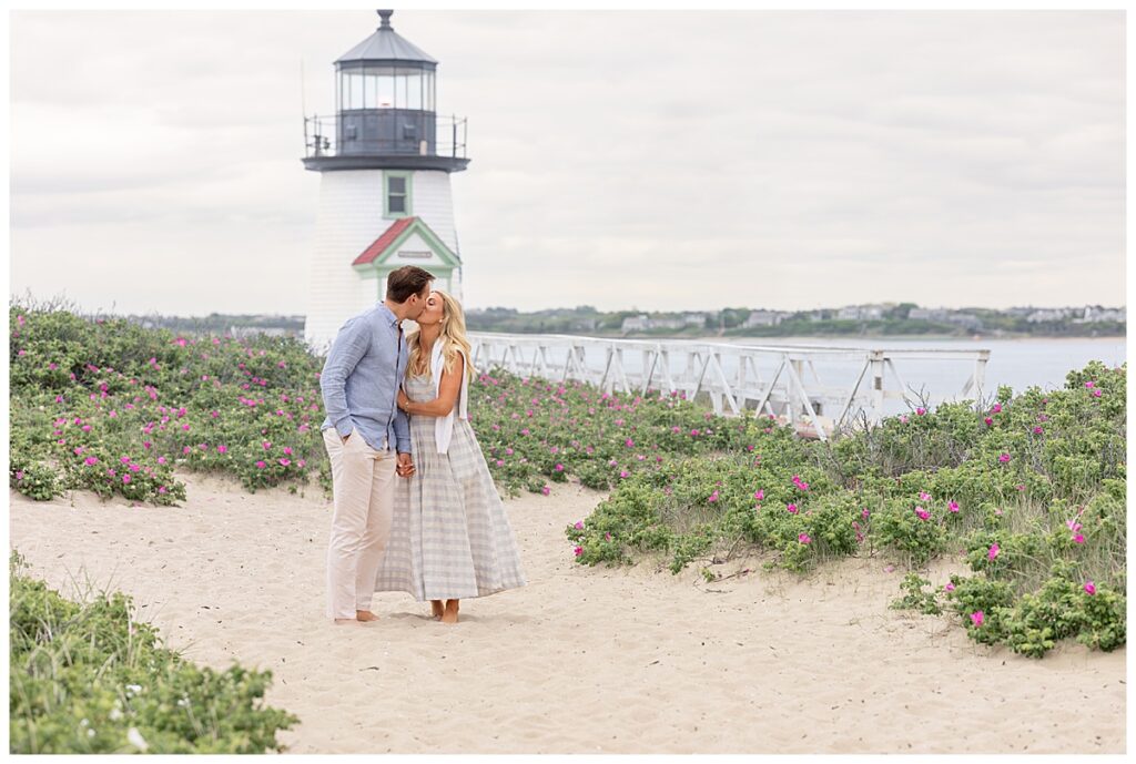 Couple kiss and walk in Nantucket after his Nantucket Proposal at Brant Point.