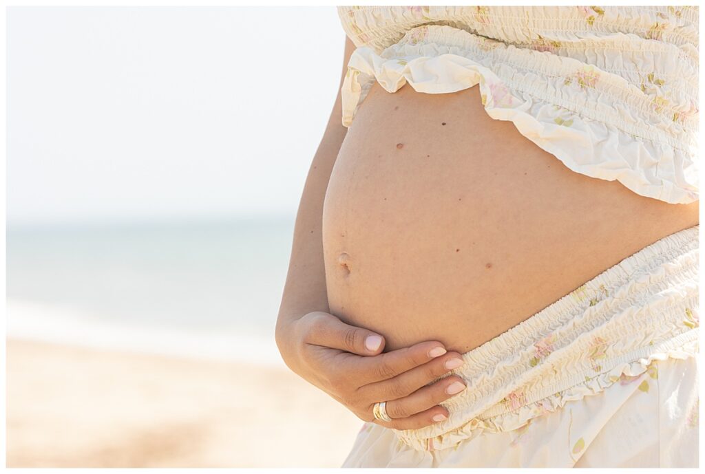 Pregnant belly in Nantucket at the beach in Sconset.