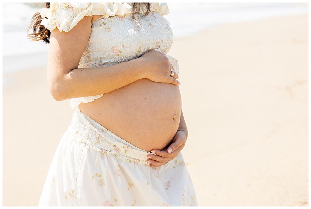Woman's pregnant belly is exposed while having maternity pictures taken in Siasconset, Nantucket.
