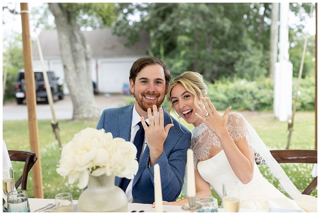 Bride and Groom smile and show off wedding bands at their Chatham, Cape Cod Massachusetts wedding.