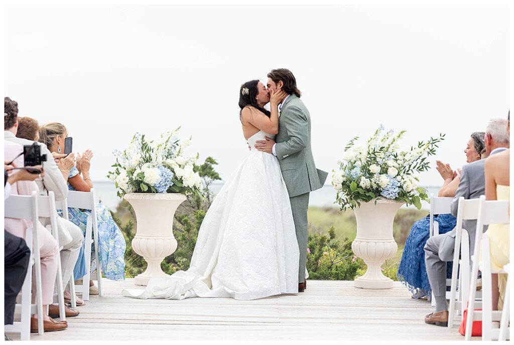 Bride and Groom share a first kiss at their Nantucket wedding on the Zen Deck at The Wauwinet.