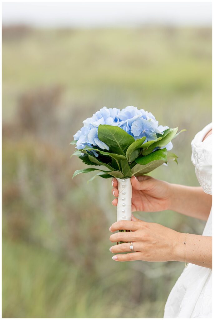 Bridal bouquet of hydrangeas and pearl pins at The Wauwinet in Nantucket.