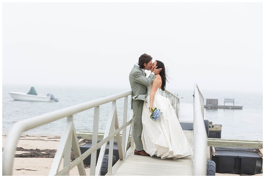 Bride and Groom share a kiss on the dock at The Wauwinet in Nantucket.
