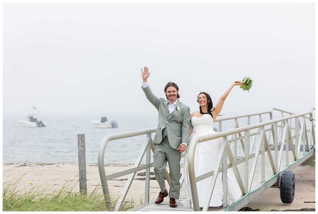 Bride and Groom cheer and smile walking on the dock at The Wauwinet in Nantucket.