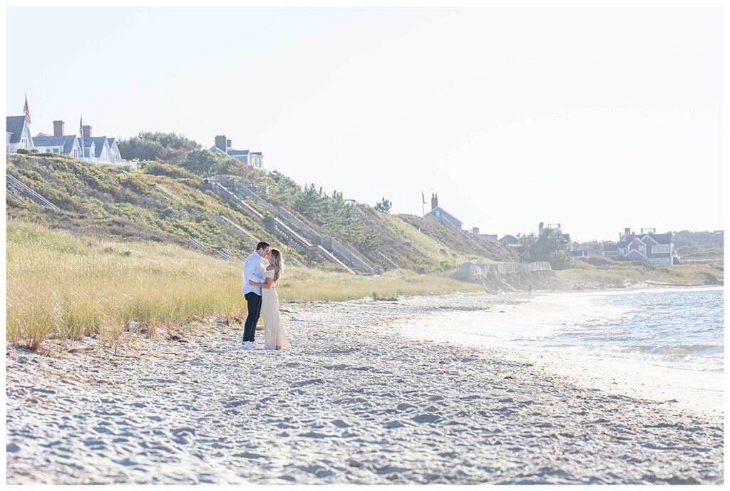 Man and woman share a kiss right before he gets down on one knee for his Nantucket Proposal at Steps Beach over Labor Day weekend.