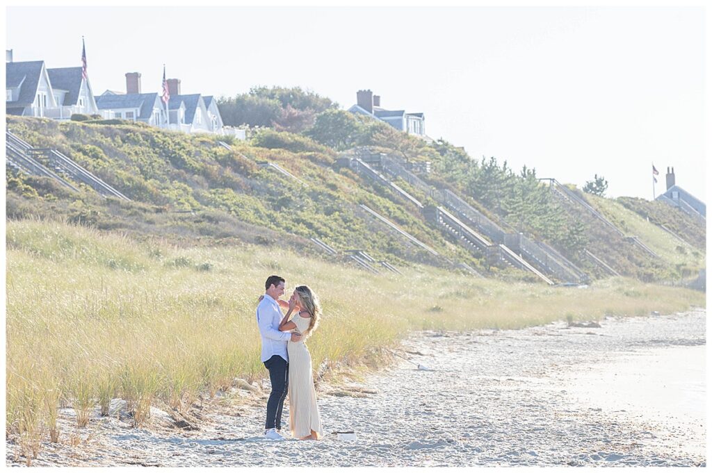 Woman wipes a tear away from her eye after mans Nantucket Proposal at Steps Beach over Labor Day weekend.