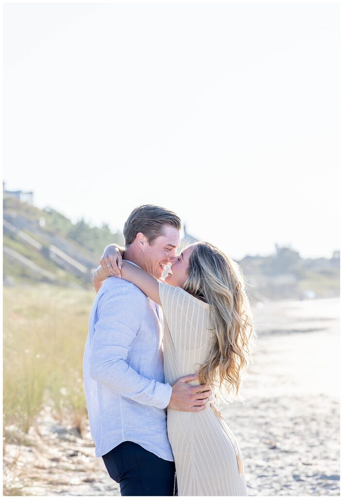 Man and woman share an almost kiss after his Nantucket Proposal at Steps Beach over Labor Day weekend.