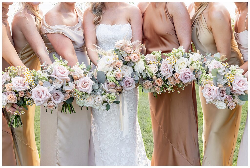 Bouquets of the bride and bridesmaids on the lawn at The Lakehouse, a Sapphire Event Group venue in Halifax, Cape Cod, Massachusetts.